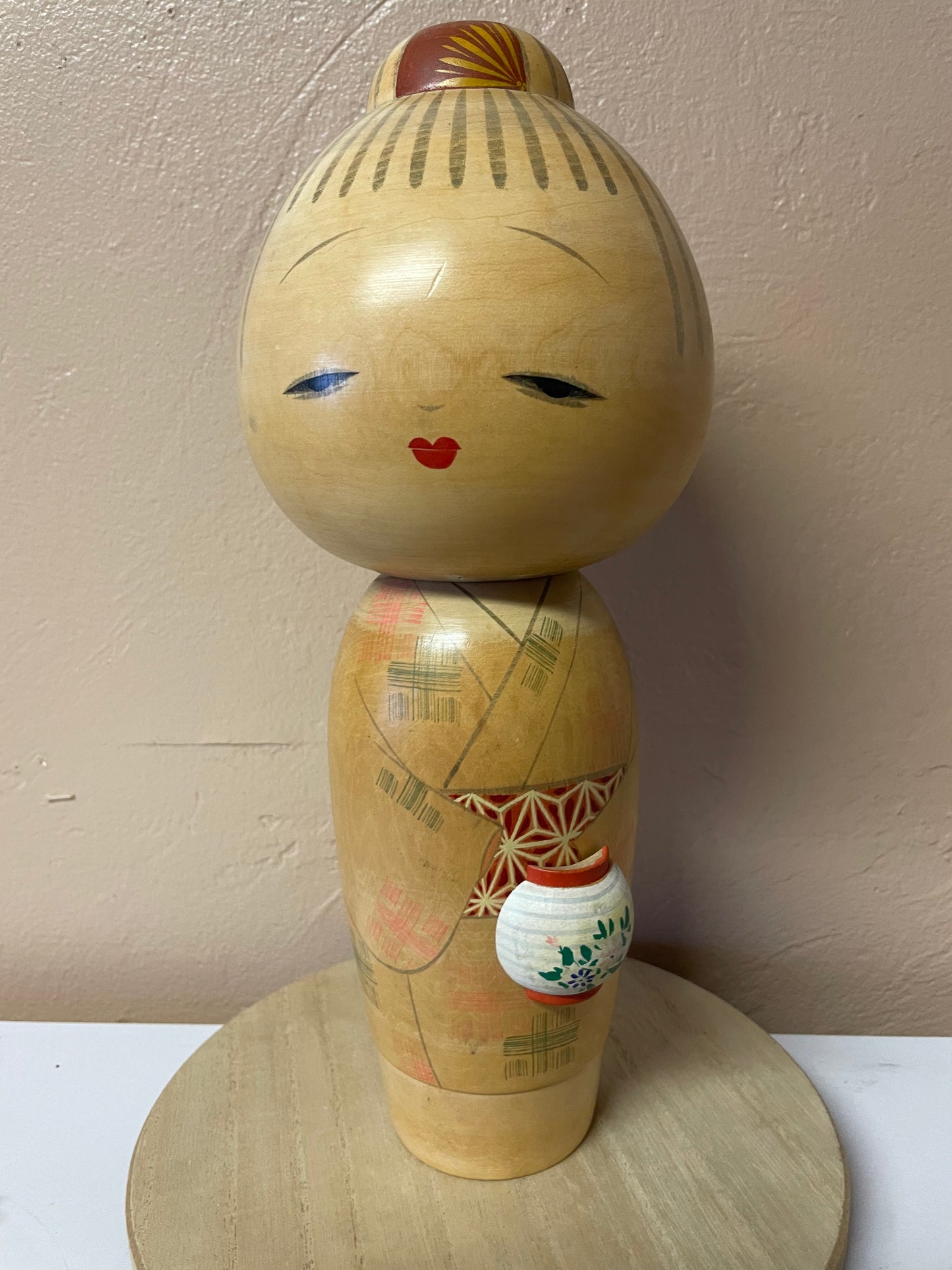 Kokeshi carrying a lantern